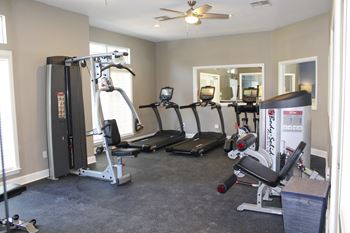 Fully-equipped fitness center with free-weights, treadmills, mounted TVs and elliptical machines